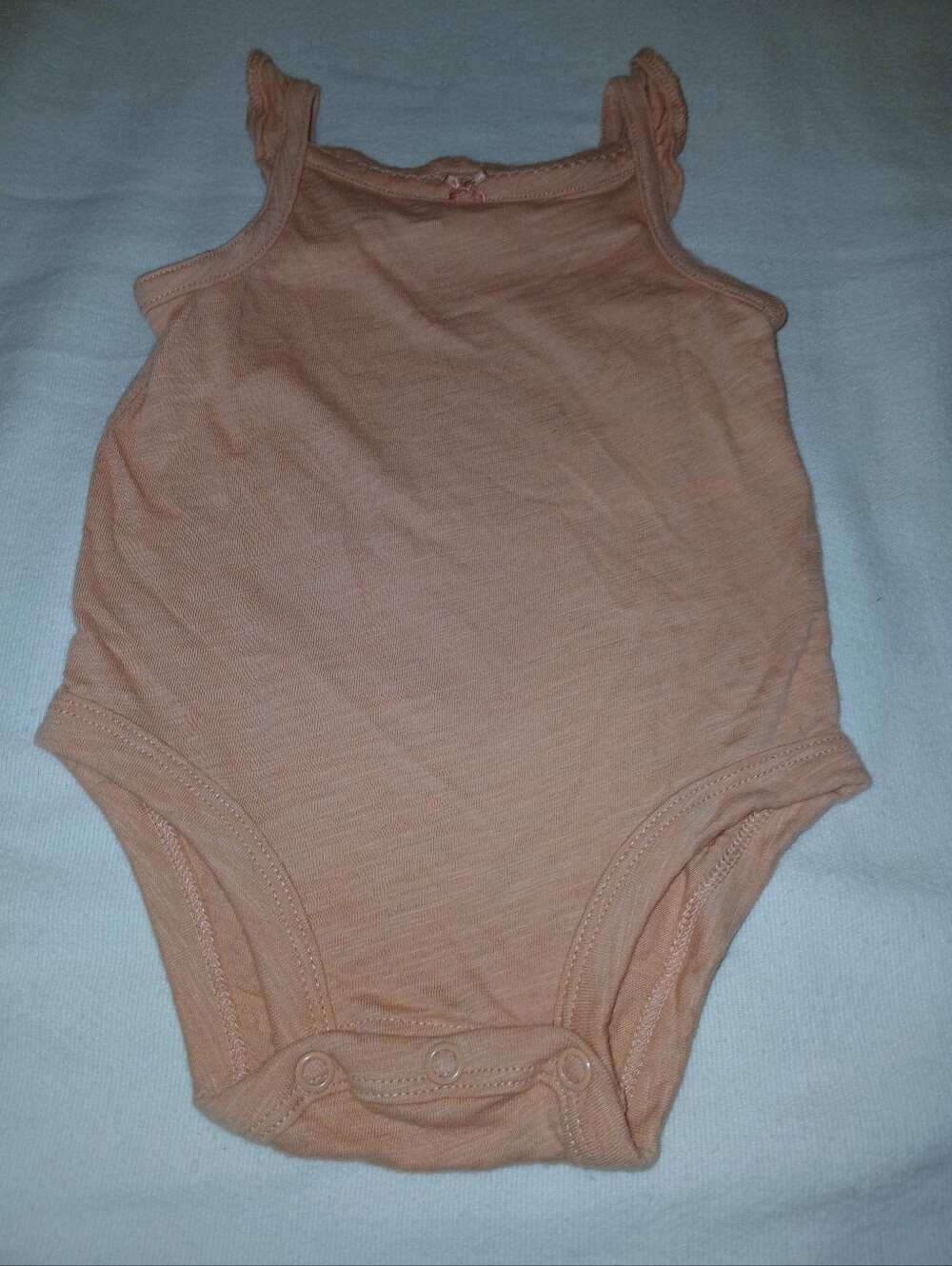 NWOT Sleeveless Peach Baby One-Piece Bodysuit.